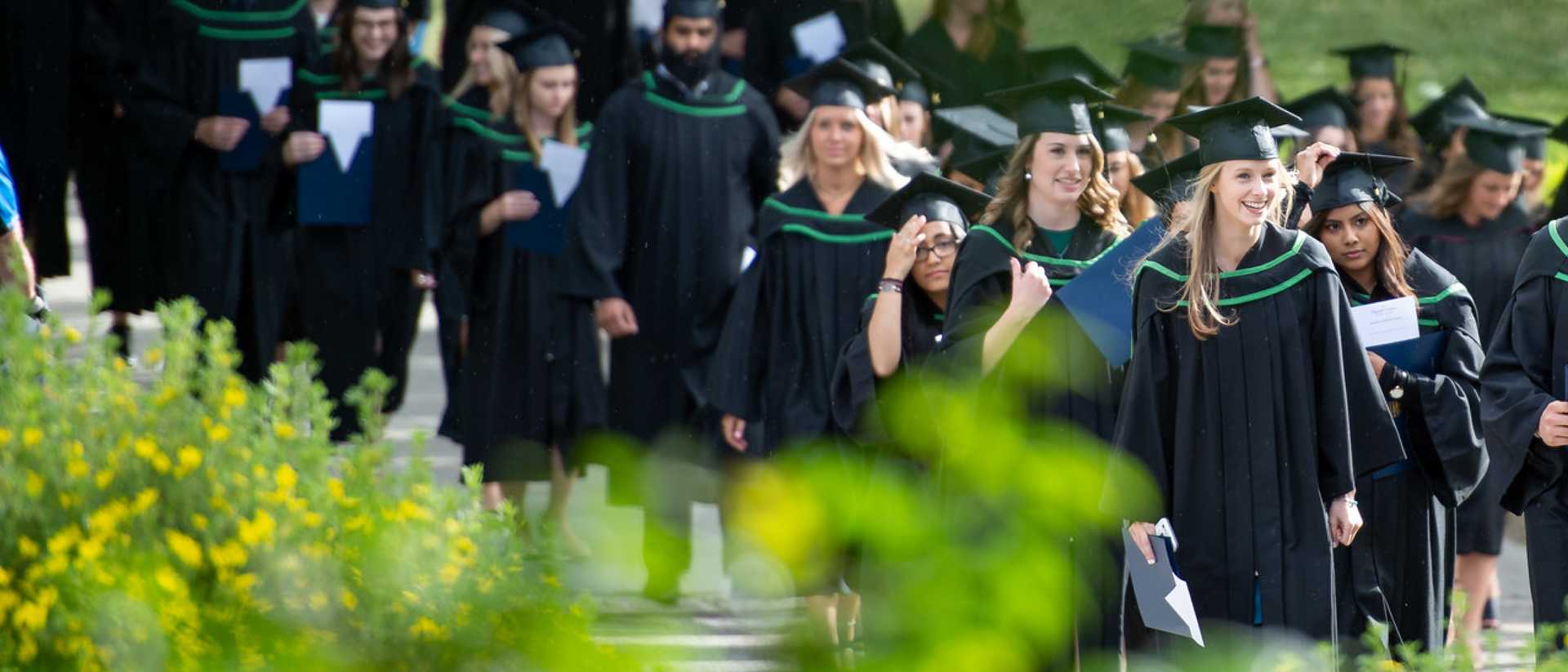 A group of UBC graduates walk across the Okanagan campus